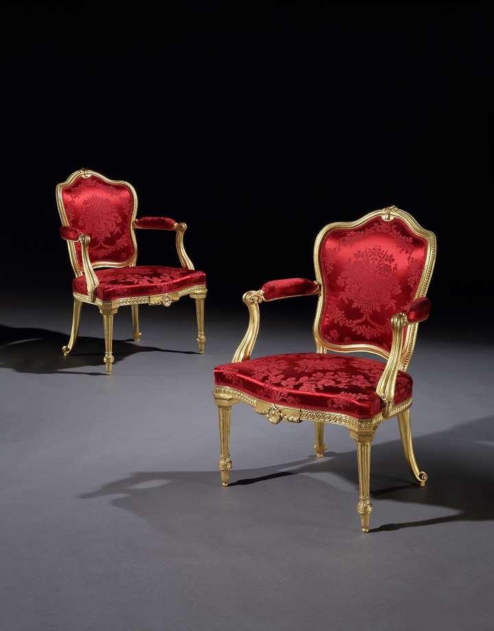 A pair of giltwood armchairs
